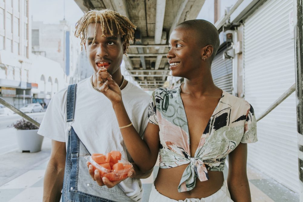 Couple snacking on fruit in the summer